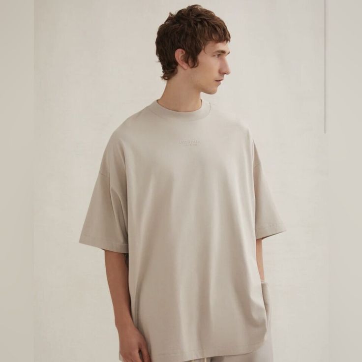 New With Tags. The Essentials Tee Shirt Returns To A Classic Crew Neckline While Maintaining The Relaxed Proportions In The Body And Sleeves. The Essentials Fear Of God Logo Is Sized Subtly In A Rubberized Soft-Touch Applique. A Fear Of God Rubberized Label Is At The Back Collar. Beige Short Sleeve T-shirt For Loungewear, Beige Relaxed Fit Plain T-shirt, Basic Khaki Short Sleeve Tops, Khaki Cotton Top For Loungewear, Relaxed Fit Cotton Tops In Neutral Color, Relaxed Fit Neutral Cotton Top, Cotton Neutral Relaxed Fit Tops, Neutral Cotton Tops With Relaxed Fit, Neutral Relaxed Fit Crew Neck T-shirt