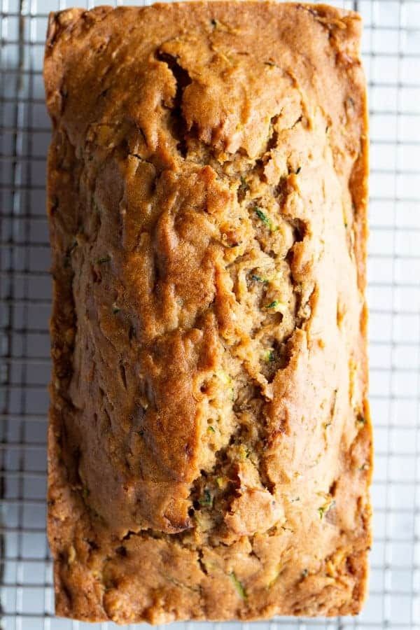 a loaf of zucchini bread on a cooling rack