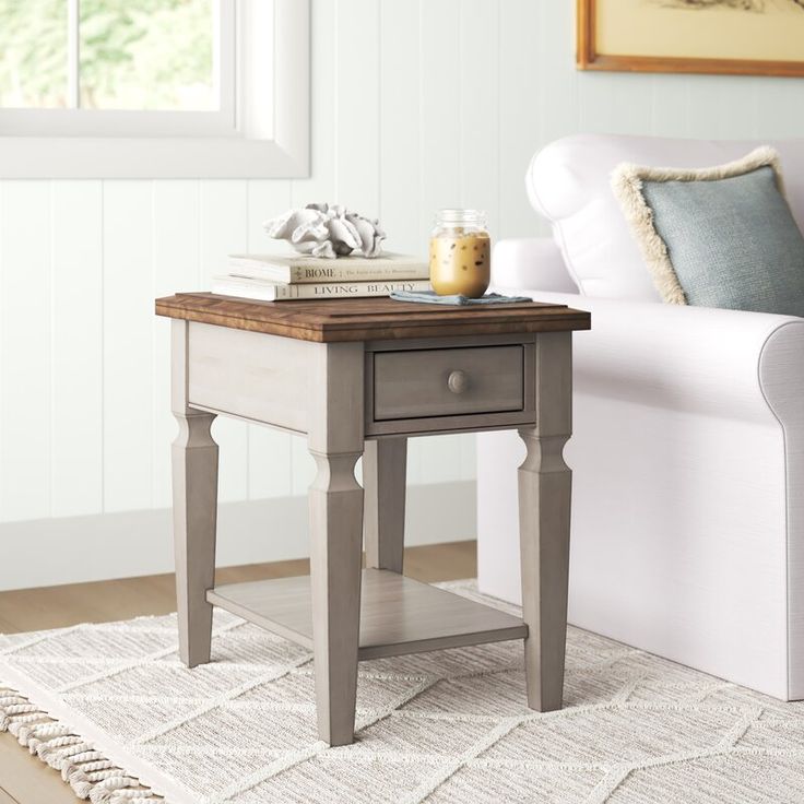 a living room with a white couch and a small end table on top of it