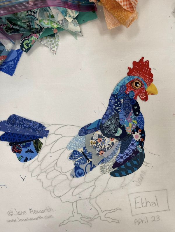 a drawing of a rooster made out of fabric and scraps on a white background