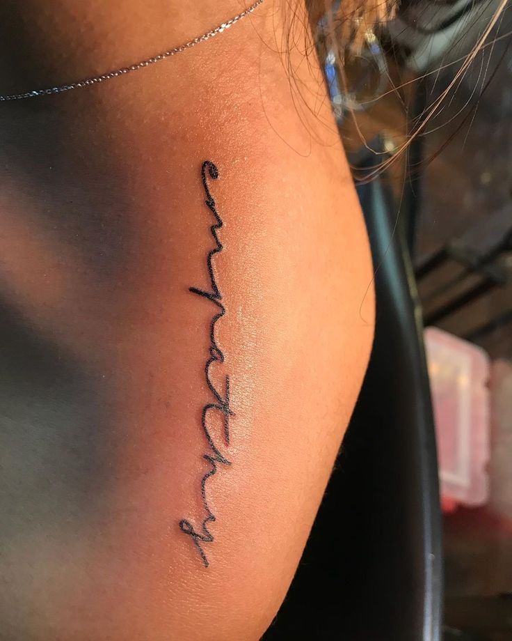 a woman's stomach with the word love written in cursive writing