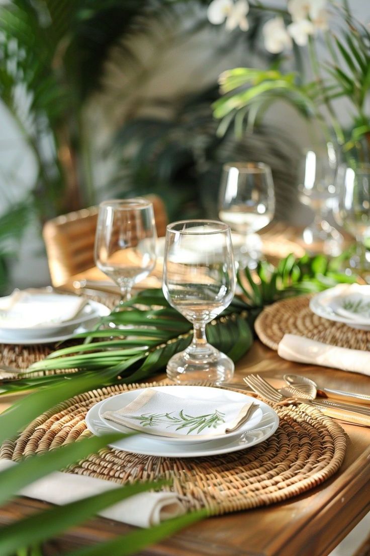 the table is set with white plates and silverware