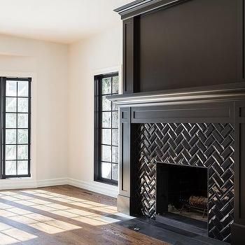 an empty living room with a fireplace and large windows