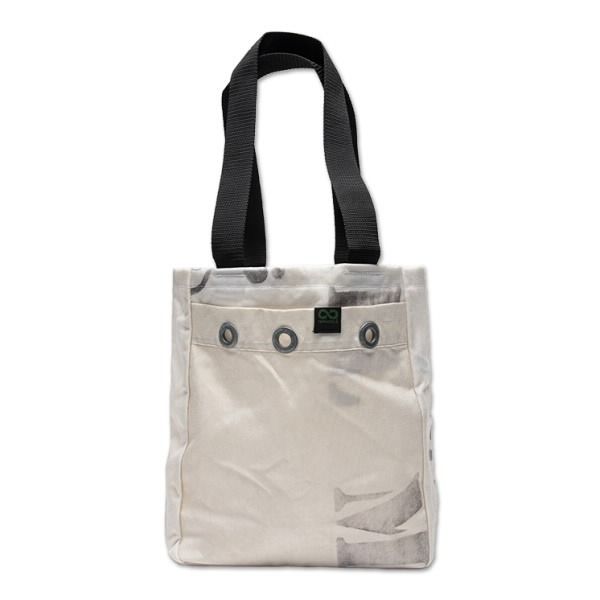 a white tote bag with black handles and two small buttons on the front pocket