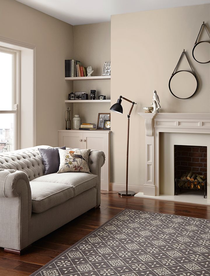 a living room filled with furniture and a fire place in front of a large window