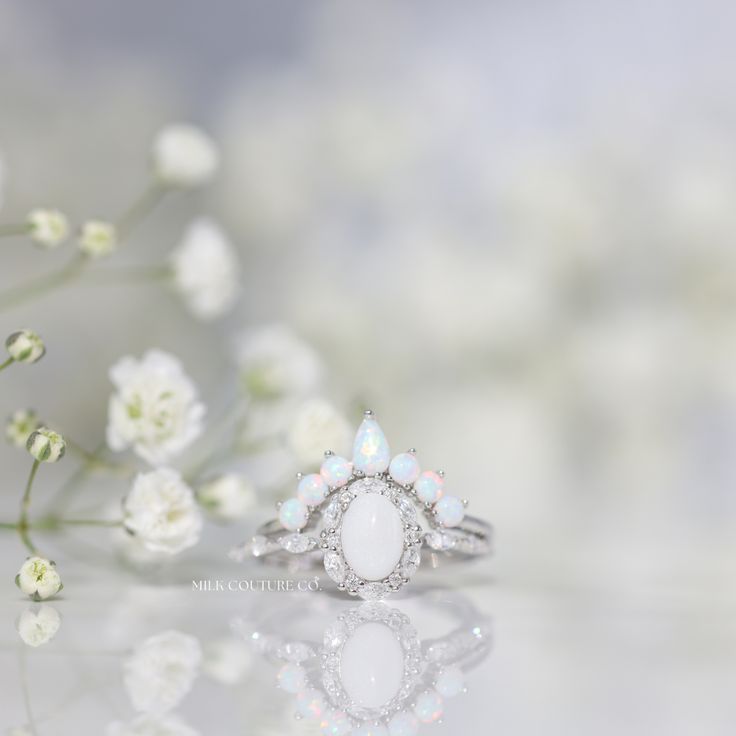 The Beautiful Dreamer ring is inspired by the 1864 song called "Beautiful Dreamer." The alternating marquise and round stone halo design is reminiscent of the graceful curves of a flower blooming. The ring has a dreamy and ethereal aesthetic, but is also classic and timeless. Elegant White Cluster Ring With Halo Design, Elegant White Marquise Rings, Marquise Halo Design Ring In Diamond White, Elegant White Teardrop Moonstone Ring, White Flower Ring With Diamond Accents For Wedding, Ethereal Halo Wedding Jewelry, Marquise White Sterling Silver Ring, White Marquise Cut Cluster Ring Fine Jewelry, Timeless White Marquise Cut Cluster Ring