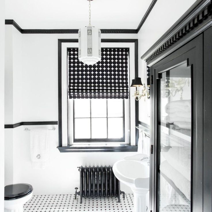 a bathroom with black and white decor in it