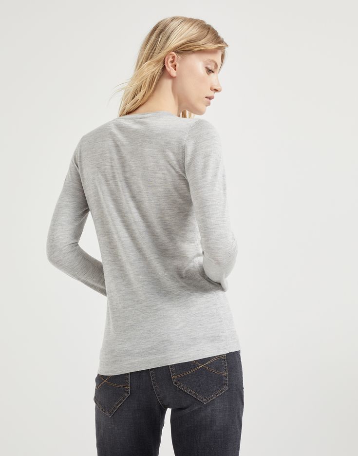 Cashmere and silk lightweight sweater The excellence of Brunello Cucinelli materials elevates the essential flavor of this cashmere and silk Sparkling yarn sweater. The lightweight, soft yarn combines the refined qualities of the natural fibers with a lamé thread which spreads delicate metallic reflections along the surface. Both regular and comfortable proportions are offered by the fit. Elegant Long Sleeve Fine Knit V-neck Sweater, Elegant Long Sleeve Merino Wool V-neck Sweater, Elegant Merino Wool Long Sleeve V-neck Sweater, Merino Wool V-neck Top For Layering, Fitted Merino Wool V-neck Top, Elegant Merino Wool V-neck Sweater For Layering, Elegant Cashmere Crew Neck Top, Elegant Cashmere Knit Top For Layering, Fitted Cashmere V-neck Sweater In Fine Knit