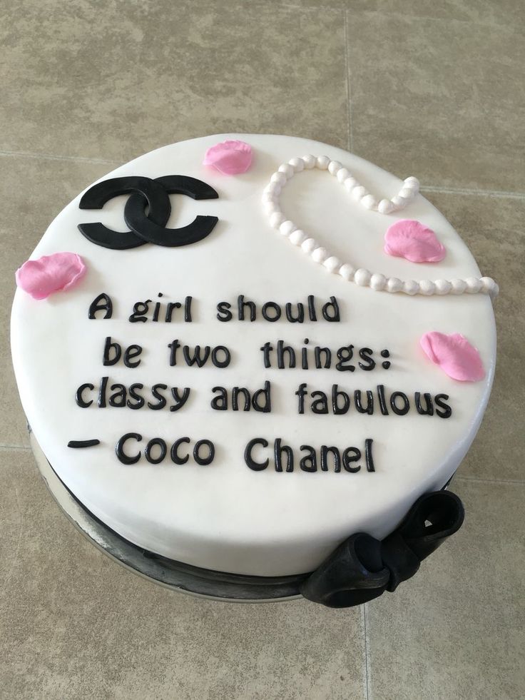 a white cake with black lettering and pink icing on the top that says, a girl should be two things classy and fabulous coco chanel