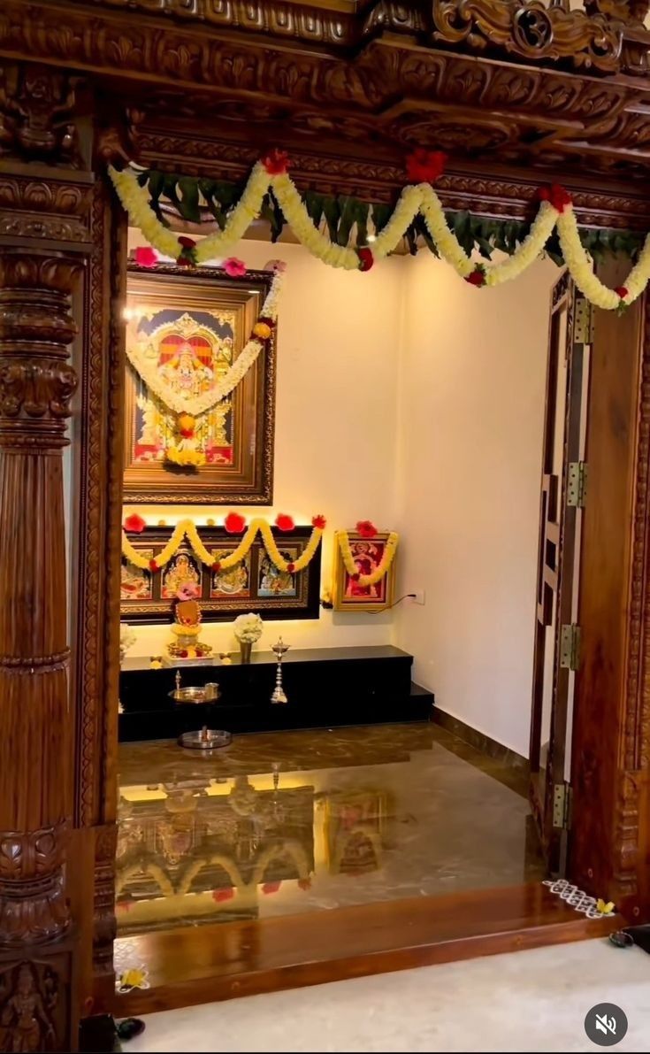 the interior of a temple decorated with flowers and garlands