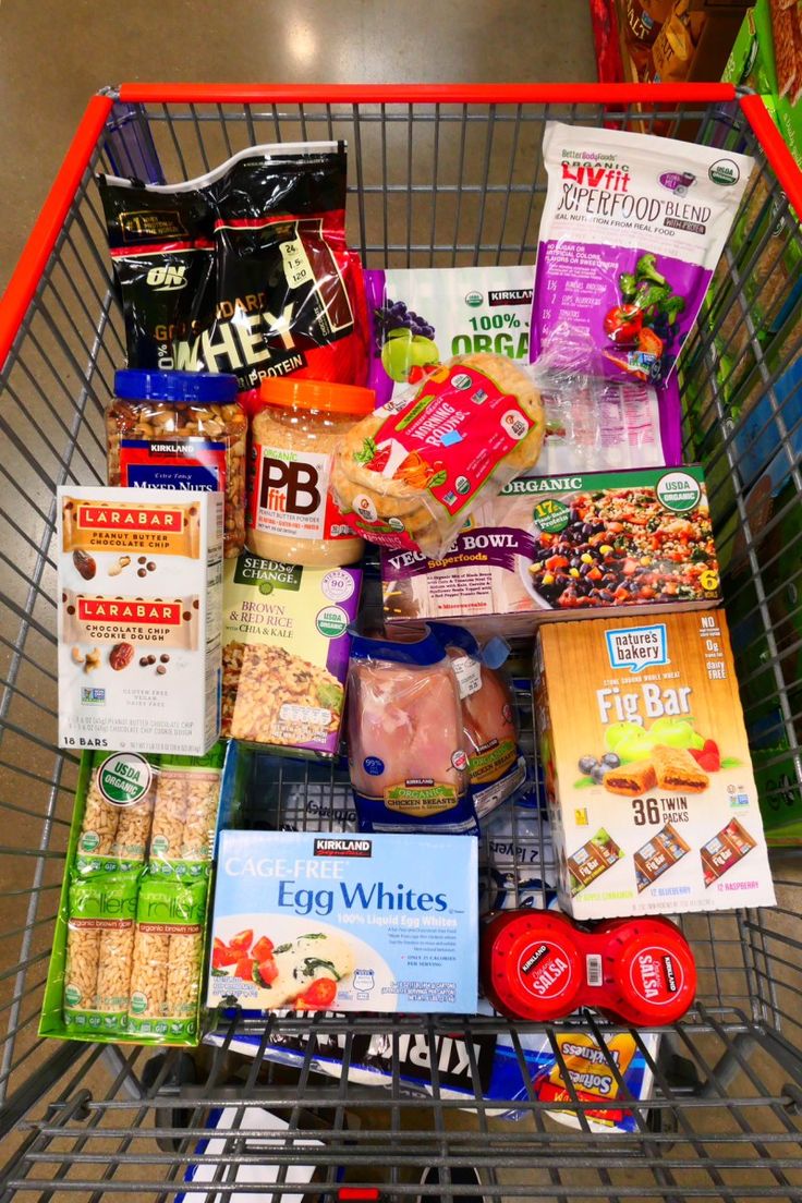 a shopping cart filled with food and snacks