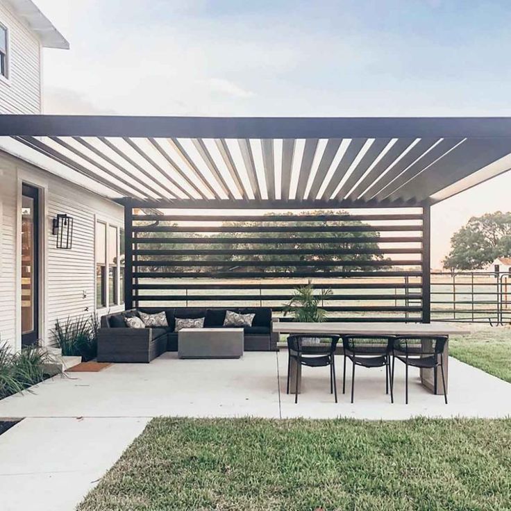 a patio covered with an awning next to a house