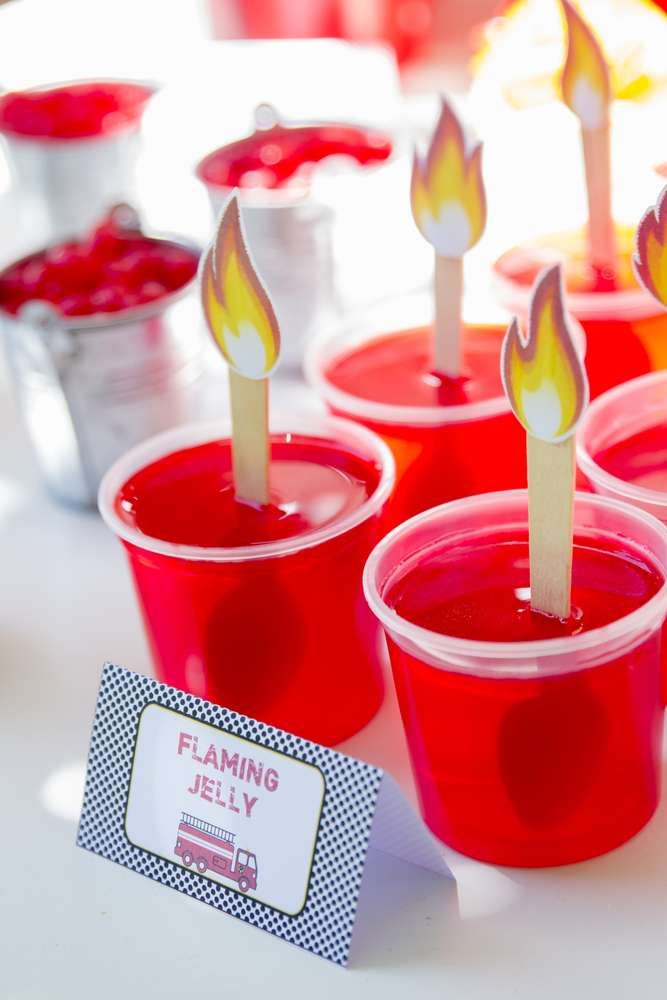 red plastic cups with candles in them on a table