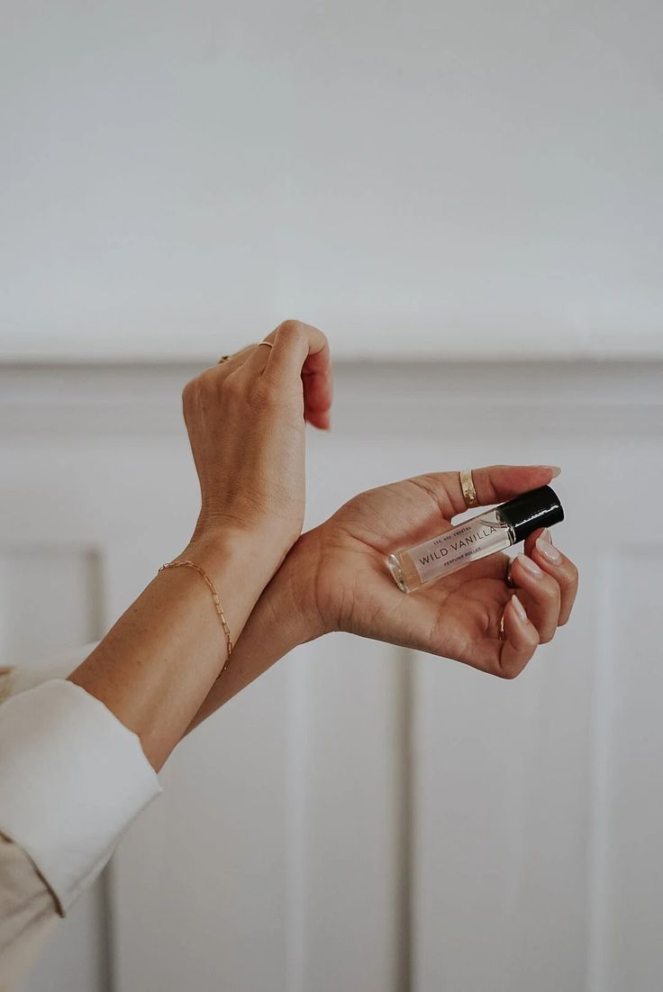 a woman is holding a small black and white object in her hand