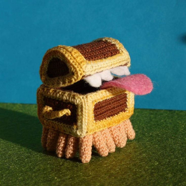 a knitted toy is sitting on the ground