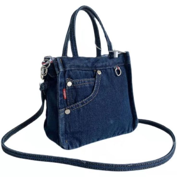 a small denim bag with a zippered pocket on the front and strap around it