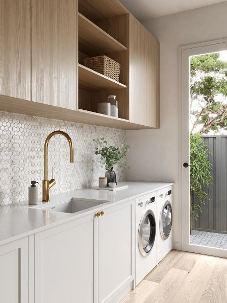 a washer and dryer in a room with open shelves on either side of the door