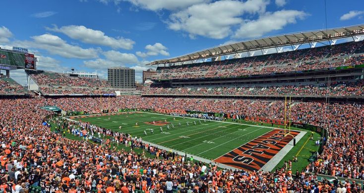 an orange and white football stadium filled with fans