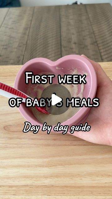 a person holding a heart shaped cup with the words first week of baby meals