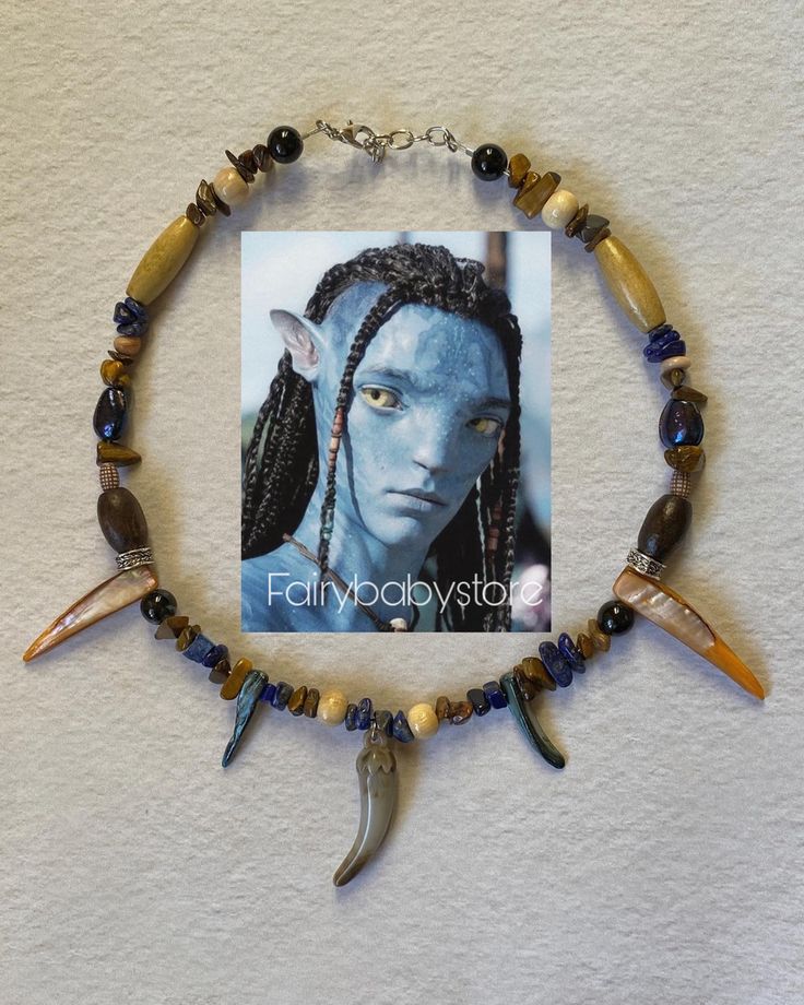 a necklace with various beads and charms on it, including an image of avatar from avatar