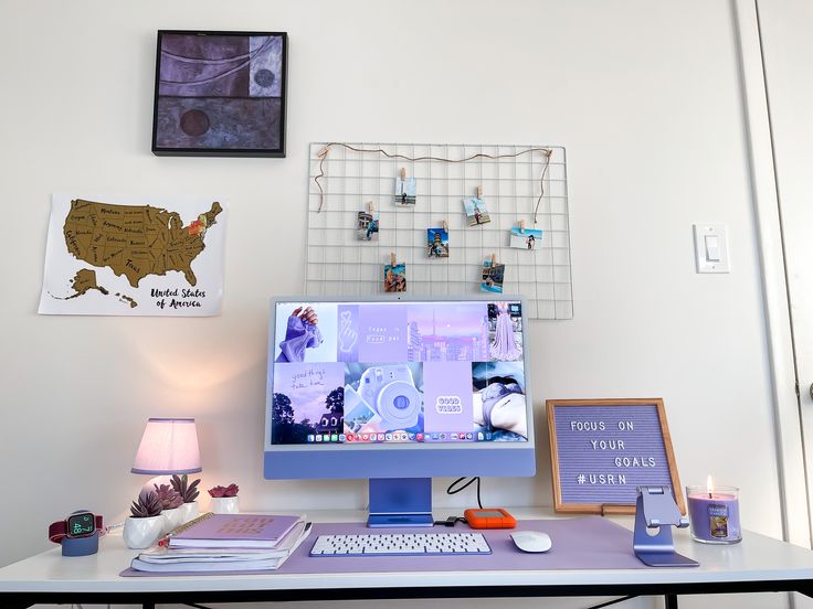 a computer monitor sitting on top of a desk next to a lamp and other items