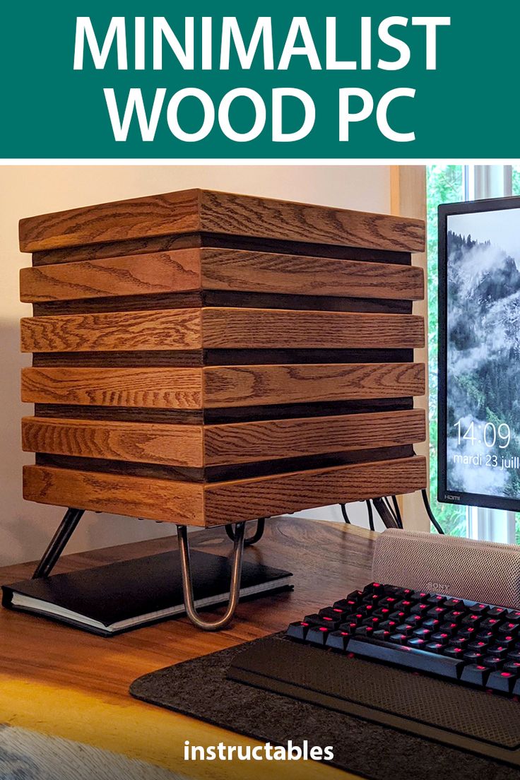 a wooden computer case sitting on top of a desk next to a keyboard and monitor