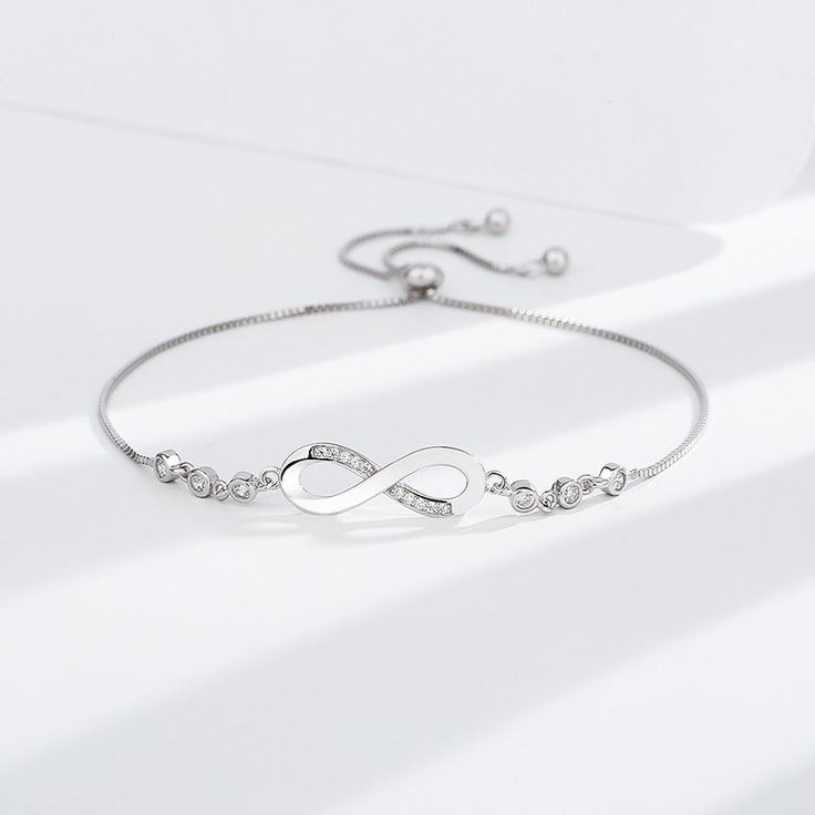 💎 Elevate Your Style with Sterling Silver: Choose the Silver-S925 option and experience the timeless beauty of the S925 Infinite Bracelet. Crafted from high-quality S925 sterling silver, this bracelet is not just jewelry; it's a symbol of everlasting connection and elegance. Modern Sterling Silver Cubic Zirconia Bracelet Gift, Adjustable Infinity Bracelet For Formal Occasions, Timeless Silver Infinity Jewelry, Timeless Infinity Silver Jewelry, Silver Adjustable Chain Bracelet For Anniversary, Luxury Silver Infinity Bracelets, Minimalist Silver Infinity Bracelet, Silver Infinity Bracelet With Adjustable Chain, Silver Timeless Chain Bracelet As Gift