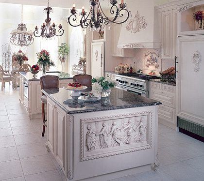 an elegant kitchen with chandeliers and marble counter tops