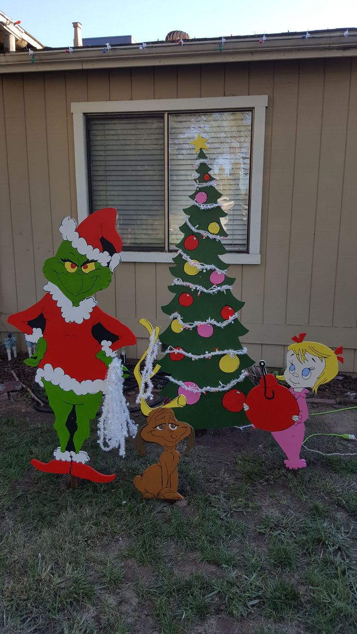 the grinch christmas tree has been decorated with santa's helper and mrs claus