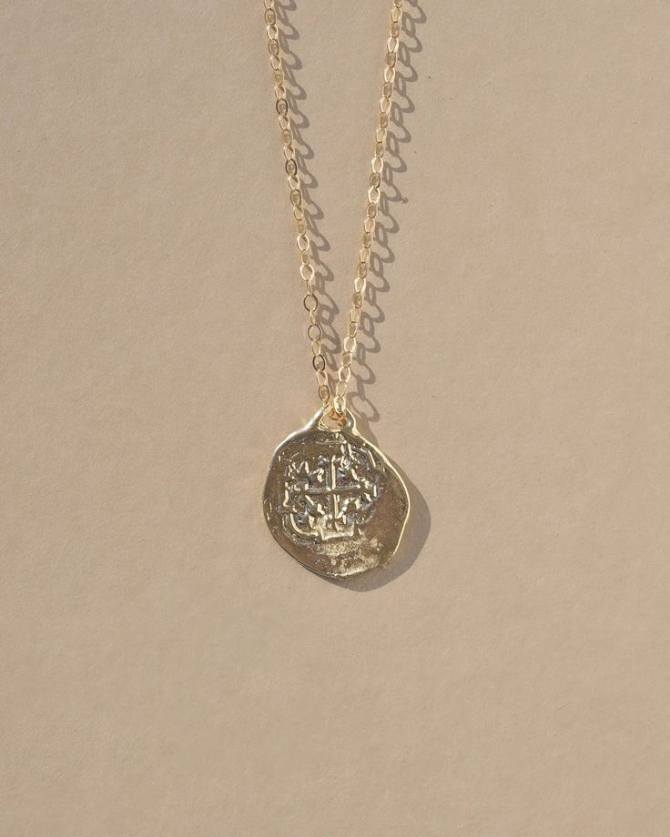 Reversible double sided Medallion charm necklace made from an old Spanish coin. A gorgeous and detailed gold necklace perfect for any occasion. Cast from an original ancient coin, the Medallion Necklace was designed to attract growth, fortune, and opportunity. Coins have a long history of bringing good luck and have be Cheap Symbolic Medallion Jewelry, Cheap Silver Medallion Necklace, Cheap Coin Pendant Necklace, Cheap Elegant Necklace With Coin Pendant, Luxury Classic Medallion Necklace With Coin Pendant, Affordable Silver Sterling Silver Coin Necklace, Affordable Bohemian Round Coin Necklace, Luxury Hammered Medallion Necklace, Luxury Engraved Sterling Silver Coin Necklace