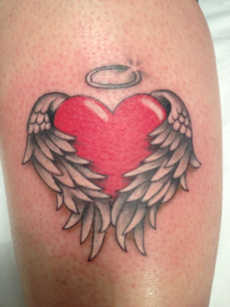 an angel heart with wings and halo tattoo on the leg, done in black and grey ink