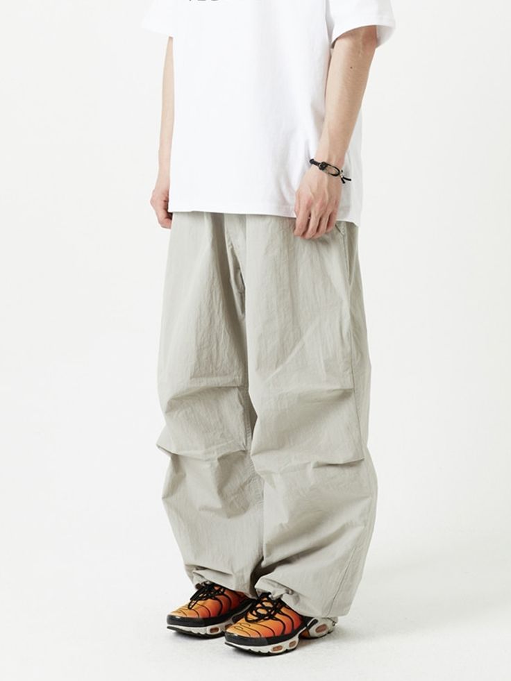 Editor's NotesThese casual pants are based on snowboard pants style and designed with comfortable banding waist and knee tucks. Cut from crisp cotton and nylon-blend, they have wide legs with a drawcord and stopper at hem to adjust fit.- Zip and button fastening - Elasticated drawstring waistband- Two front flap pockets - One back patch pocket with logo patch- Knee tucks- Adjustable drawcord hem- Wide fit- Unisex wearMeasurements (in.) M / L- Total Length: 40.9 in. / 42.1 in. - Waist: 12.6 in. / 13.4 in.- Rise: 13.0 in. / 13.8 in.- Thigh: 14.6 in. / 15.4 in.- Hem: 11.0 in. / 12.2 in.Model info: - Man: 5' 11.7, 149.9 lbs- Woman: 5' 3.4, 97.0 lbs Composition & Care- 60% Cotton, 40% Nylon- Button: Permex- Zipper: YKK- Refer to the care label- Due to nature of attaching patch with hig Spring Outdoor Parachute Pants, Spring Outdoor Solid Color Parachute Pants, Relaxed Fit Wide-leg Cargo Pants For Outdoor, Gray Cotton Parachute Pants For Outdoor, Relaxed Fit Parachute Trousers, Spring Urban Parachute Pants, Relaxed Fit Wide Leg Nylon Parachute Pants, Spring Parachute Pants With Elastic Waistband For Outdoor, Solid Wide-leg Techwear Parachute Pants