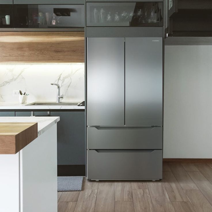 a modern kitchen with stainless steel appliances and wood flooring