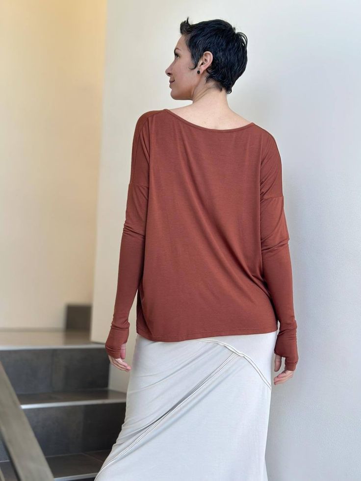 Boyfriend Top Our long sleeve Boyfriend Top is about to become your everyday go-to top. It has a relaxed fit and is made from a soft lightweight rayon jersey that drapes easily on all figures. This tee can also double as a shrug, making it an ideal travel top. One Size (O/S) Colors This long sleeve jersey is available in these colors: Steel Copper Teal Black Jam Navy Wine Canal Blue Plum Learn MoreInterested in learning more about our plant-based fabrics made in small batches and our jewel-tone Versatile Long Sleeve Top With Soft Stretch, Versatile Soft Stretch Long Sleeve Top, Long Sleeve Modal Tops For Fall, Versatile Long Sleeve Fine Knit Top, Versatile Fine Knit Long Sleeve Top, Long Sleeve Top With Thumbholes, Effortless Relaxed Fit Long Sleeve Top, Effortless Long Sleeve Relaxed Fit Top, Effortless Long Sleeve Top With Relaxed Fit