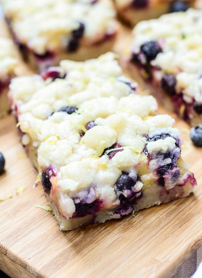 blueberry crumb bars on a wooden cutting board