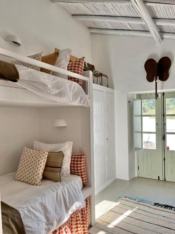 a bedroom with bunk beds and white walls