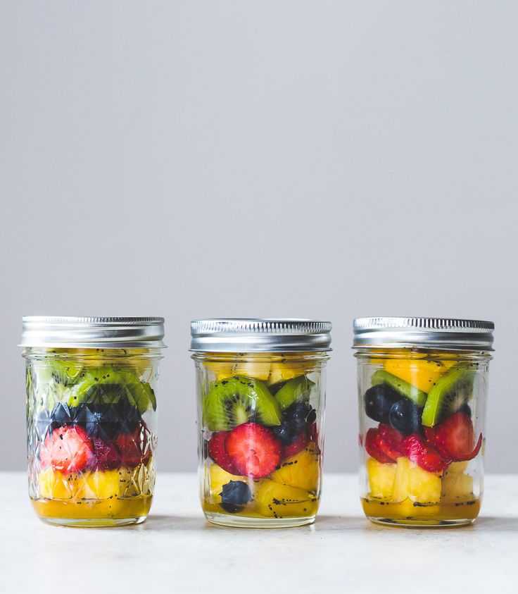 three jars filled with different types of fruit