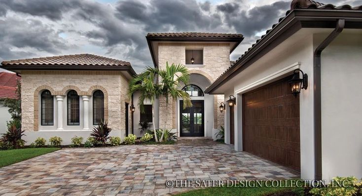 a large house that has a driveway in front of it and palm trees on the other side