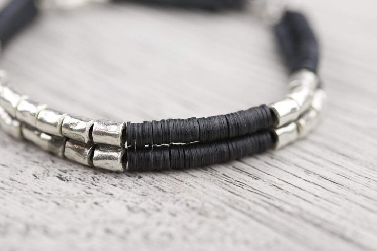 This bracelet exudes a grounding energy, bringing the wearer closer to the Earth. Made with 98% pure Hill Tribe silver beads alongside intricate stacks of African vinyl disk beads with a silver toggle clasp. The combination of light and dark presents a stylish and handsome design. Bracelet is design and sized for men, but also looks great on women. Wear it alone or pair it with a stack of your favorite bracelets, wrist malas, or even a watch. Measures approximately 8 inches around. Handmade in T Grounding Energy, Wrist Mala, Design Bracelet, Hill Tribe Silver, Toggle Clasp, Bracelet Stack, Silver Beads, The Earth, Bracelets For Men