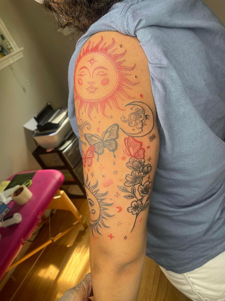 a person with a sun and flowers tattoo on their arm is looking at the camera