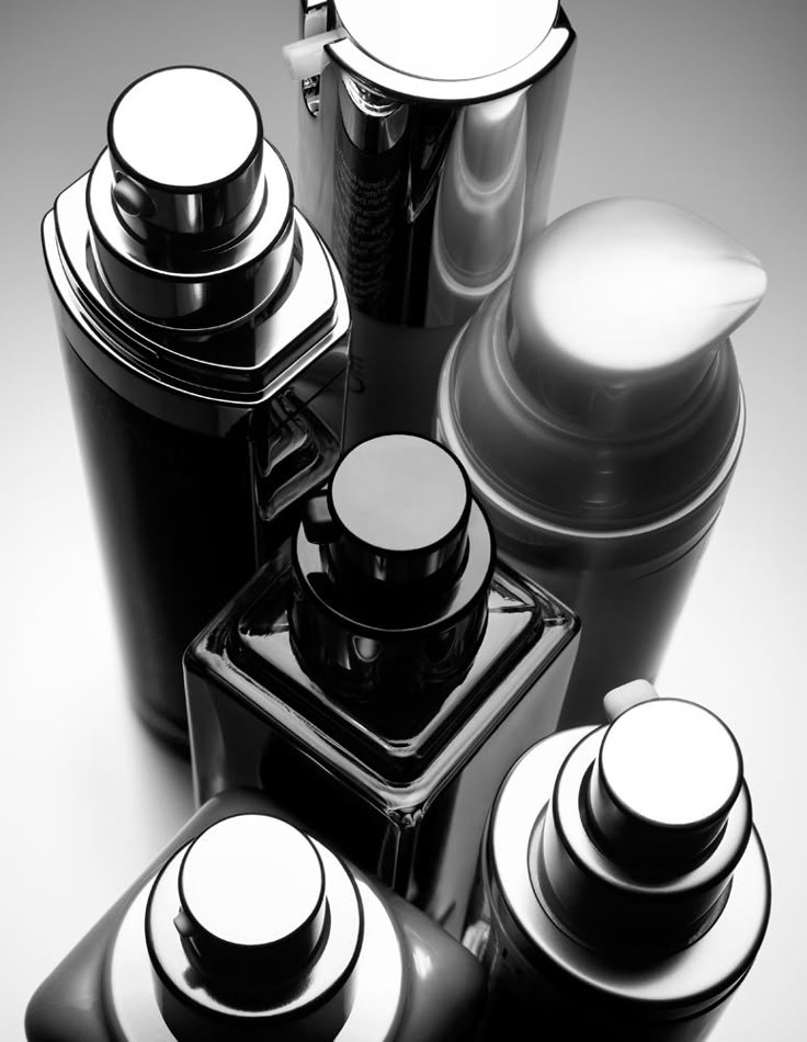 black and white photograph of various cosmetic containers