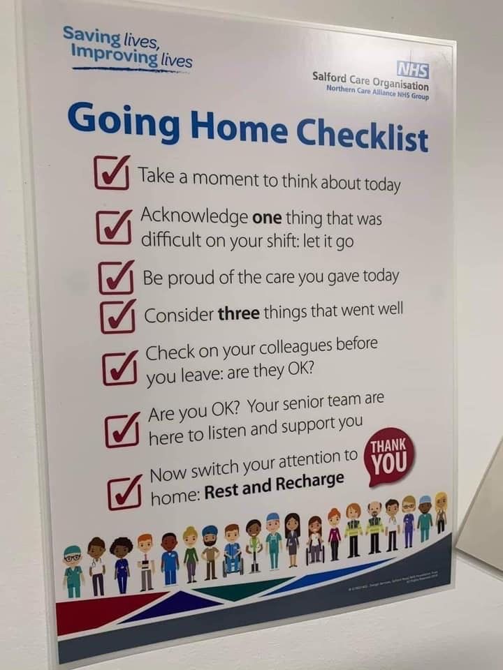 a sign that says going home checklist next to a laptop