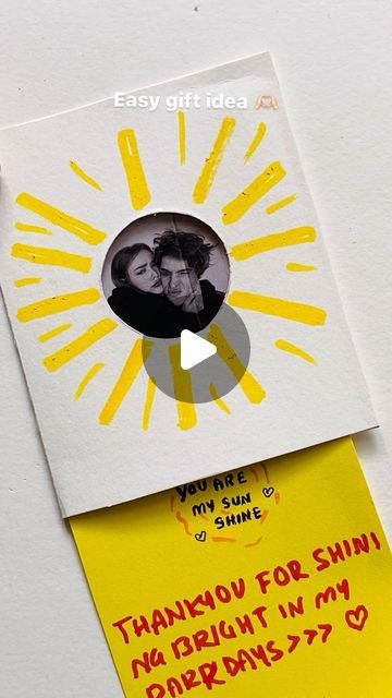 a piece of paper that has been cut out to look like a sun with two people on it