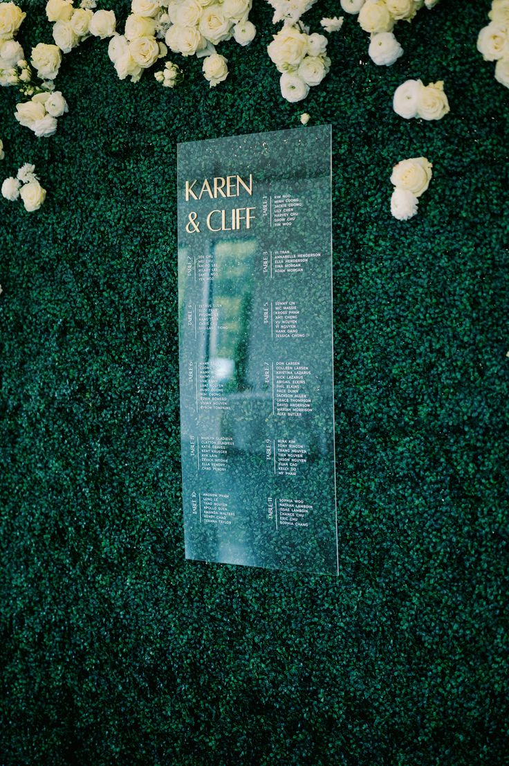 the seating chart for karni and cliff's wedding was displayed in front of flowers