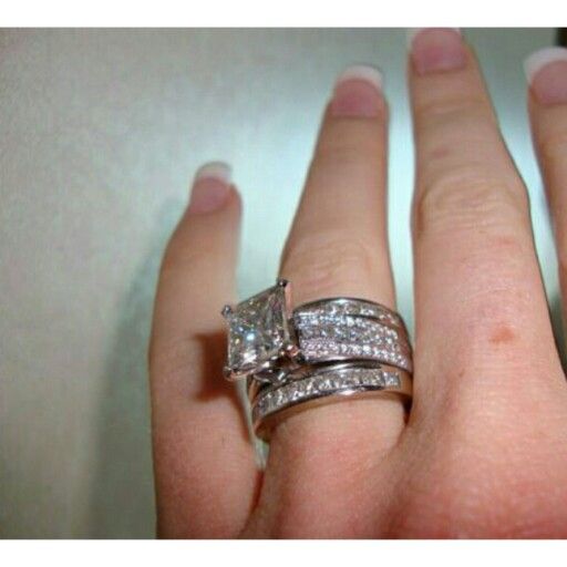 a woman's hand with two wedding rings on top of her finger and the other ring