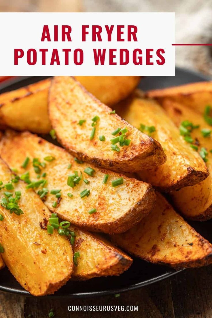 air fryer potato wedges on a black plate with green garnishes