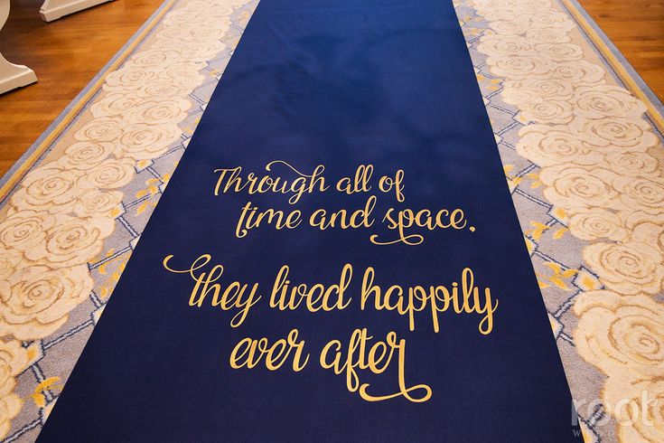 a blue and gold wedding aisle with the words through all of time and space, they lived happily ever after