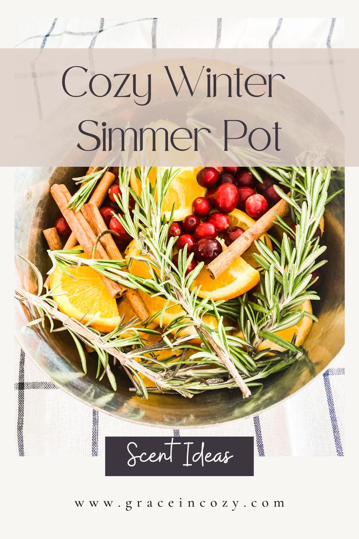 a bowl filled with cranberries, oranges and rosemary on top of a table