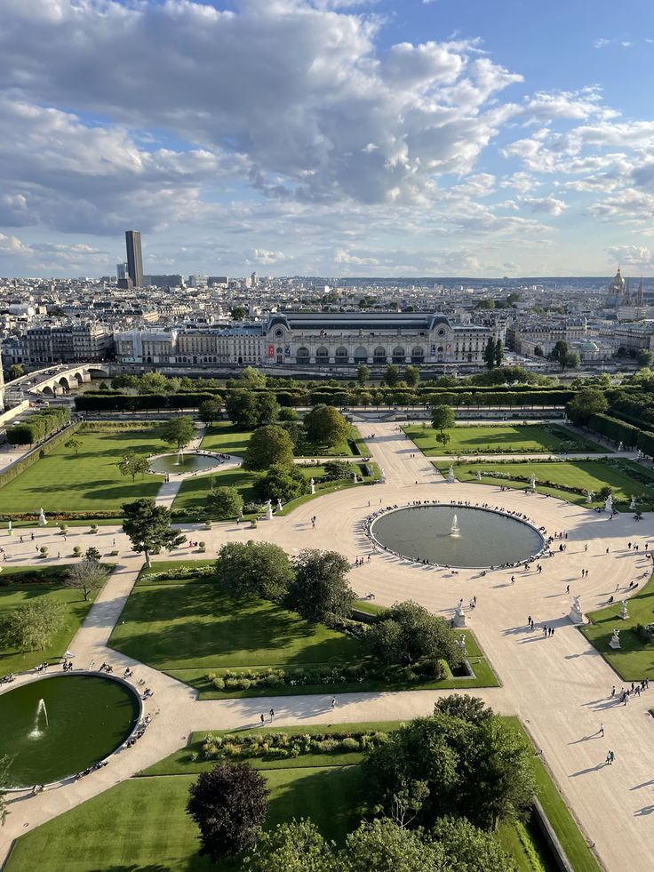 an aerial view of a city with lots of green grass