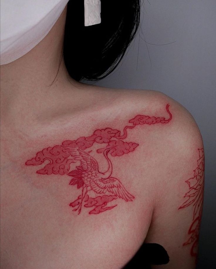 a woman with a tattoo on her shoulder